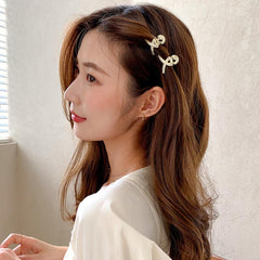 Qojai bow-shaped clip detail displaying elegant pearl accent for styling