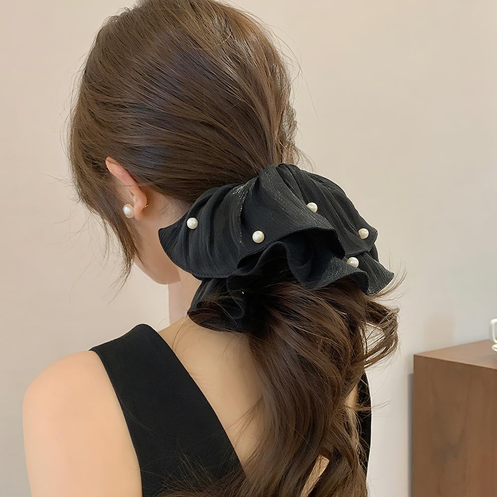 Qojai blue scrunchie styled in a low bun adding elegant shimmer and stability