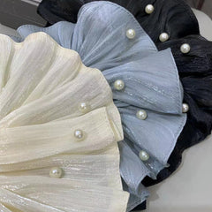 Qojai scrunchie on a table in a party setting demonstrating accessory versatility