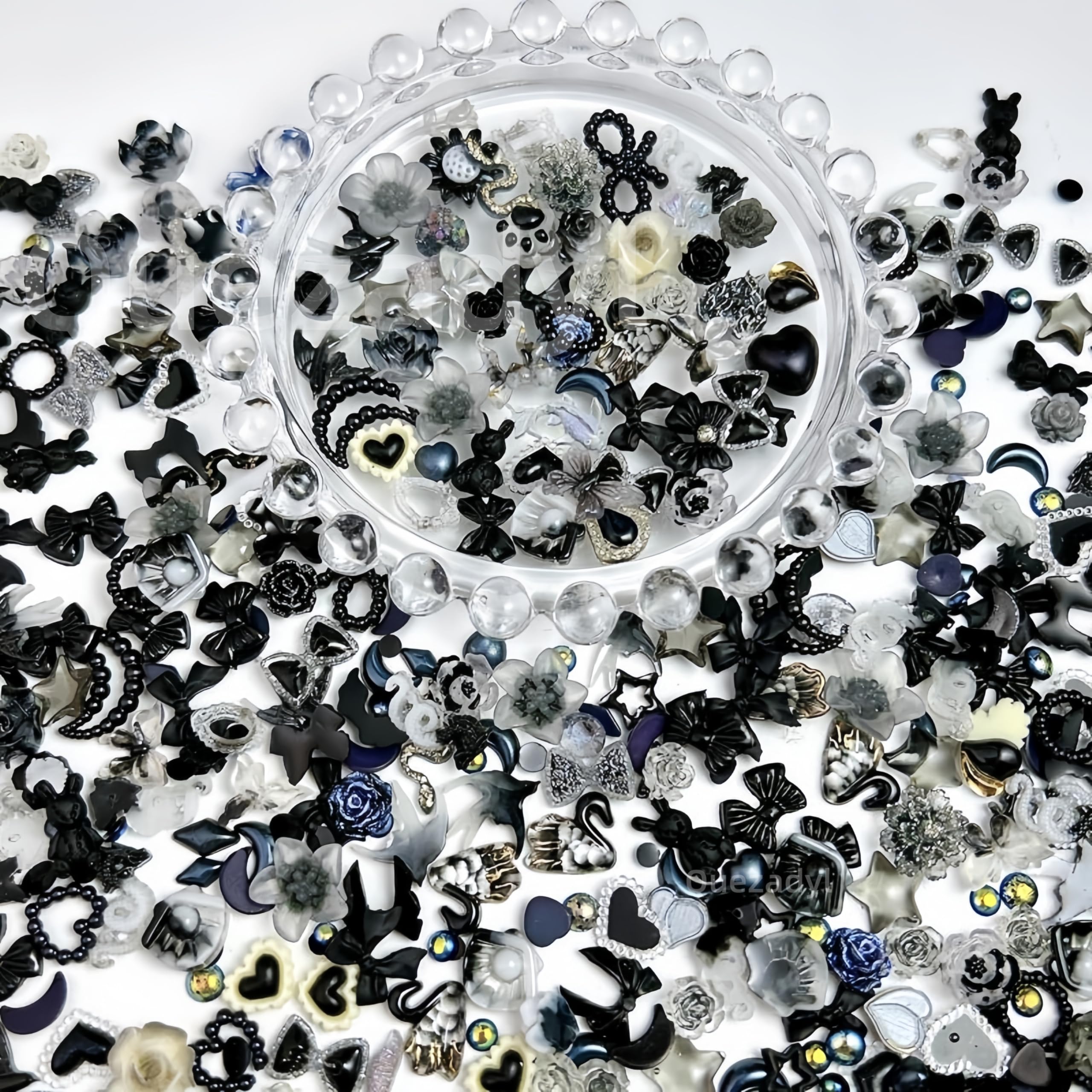 Quezadyl charms placed on acrylic nail swatches demonstrating finished look