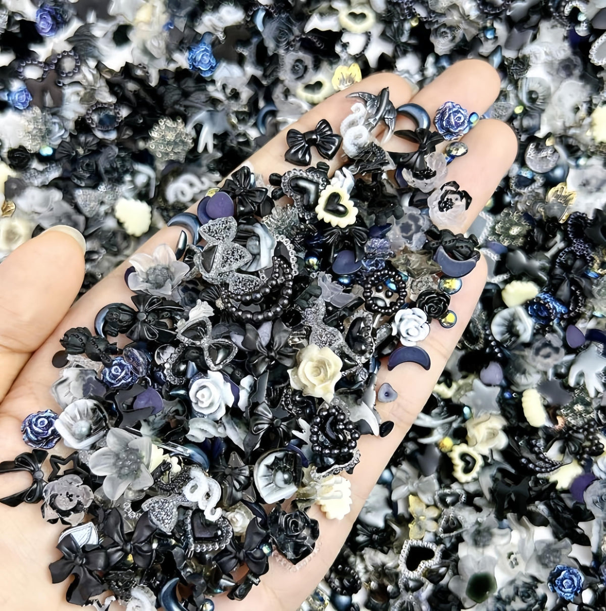 Quezadyl front packaging showing 300-piece resin nail charm assortment for variety