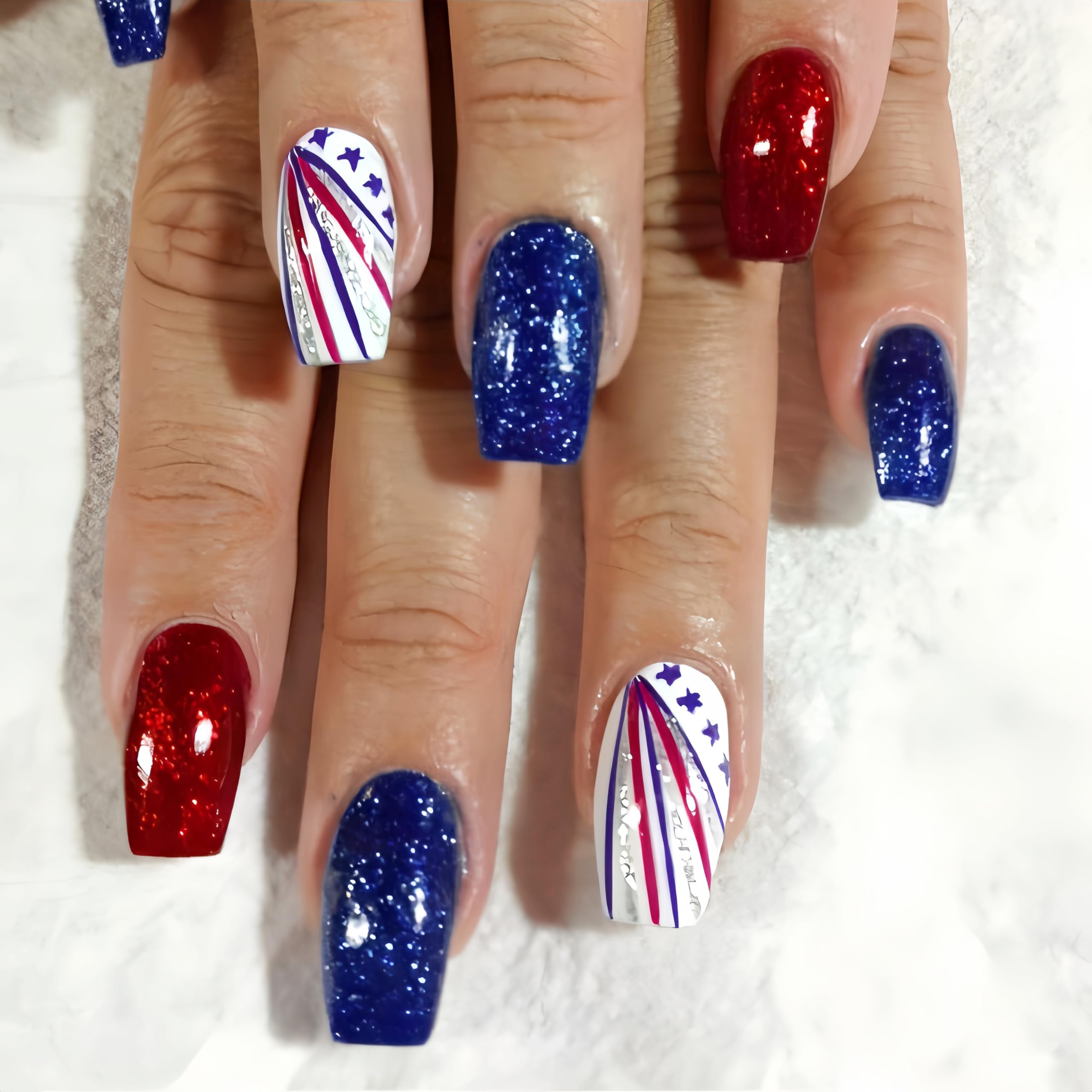 Quezadyl front packaging showing 24-piece patriotic nails and accessories for quick use