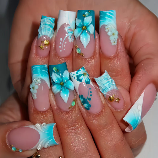 Quezadyl front packaging showing 24-piece blue flower press-on nails and tools for ready application