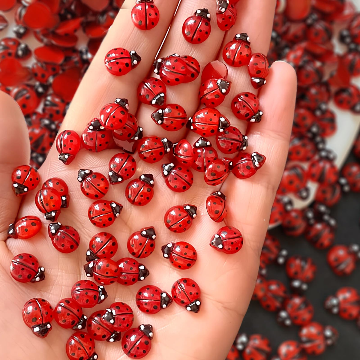 Quezadyl front packaging showing 100-piece ladybug nail charms and easy variety