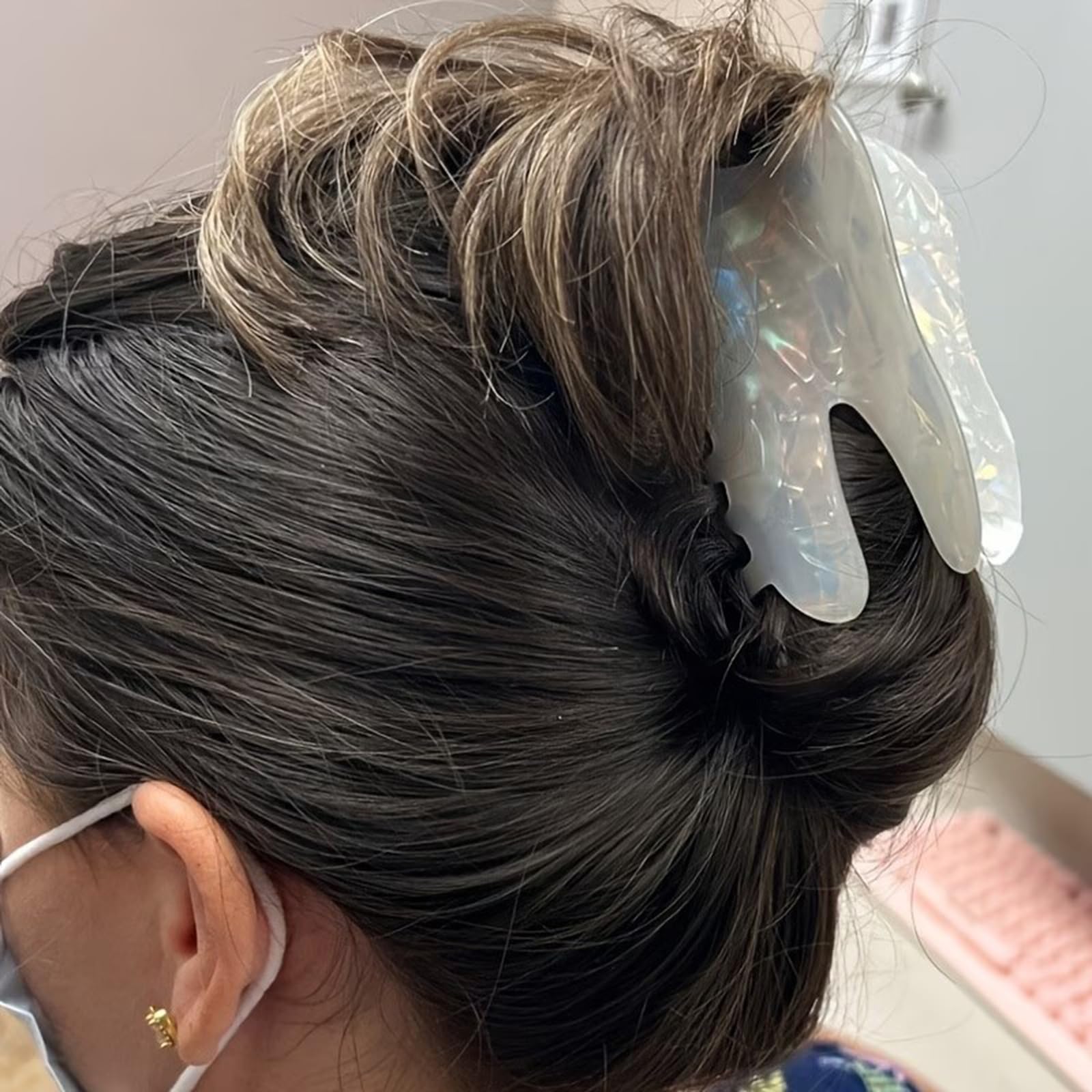 QUNITKAST clip securing a topknot hairstyle and adding playful detail