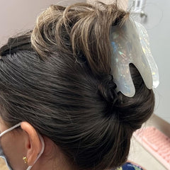 QUNITKAST clip securing a topknot hairstyle and adding playful detail