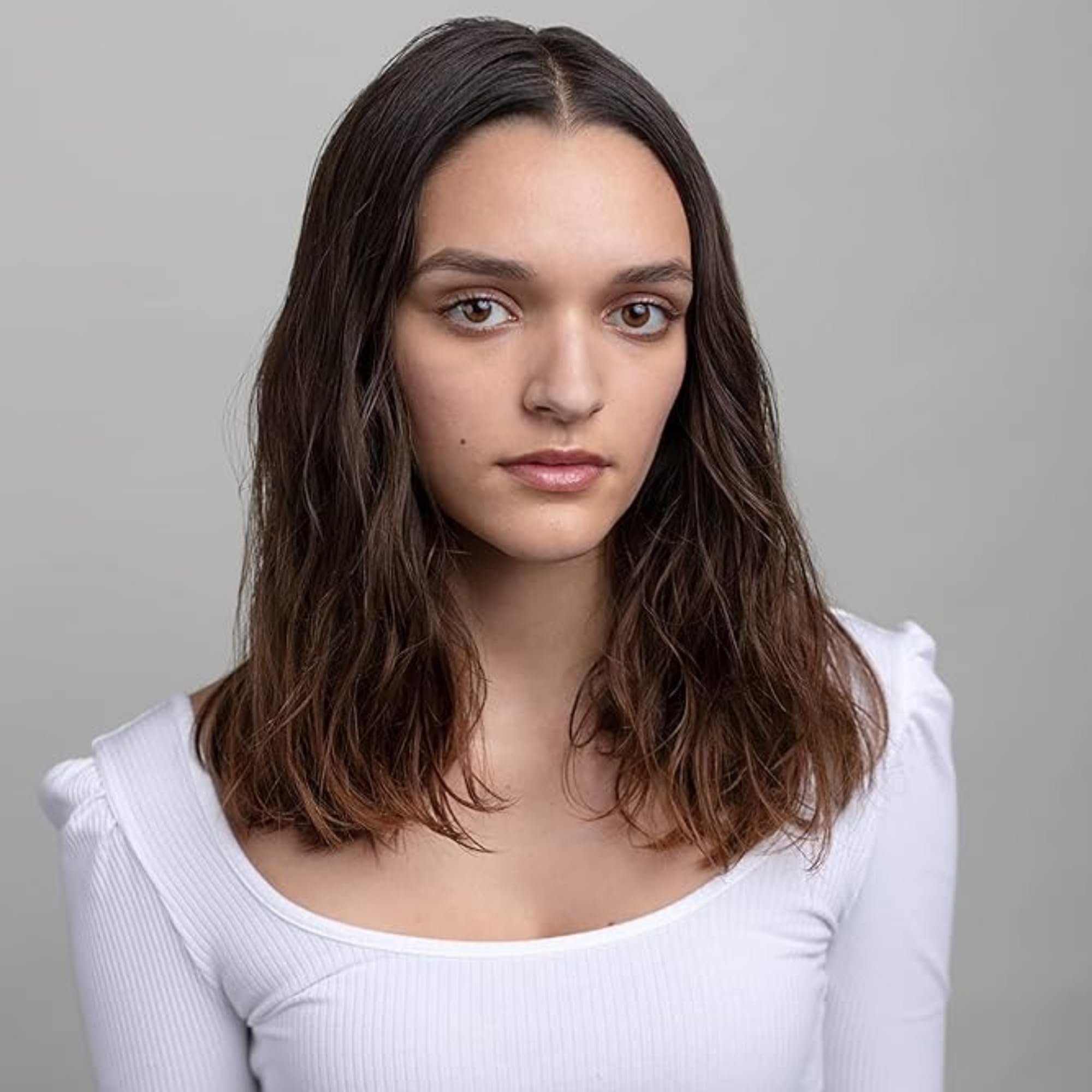 R+Co applied to damp hair illustrating frizz control and enhanced definition