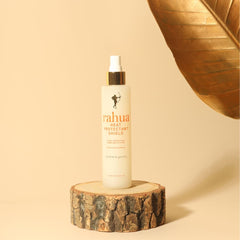 Rahua bottle held in hand to show 6.5 fl oz size and portability
