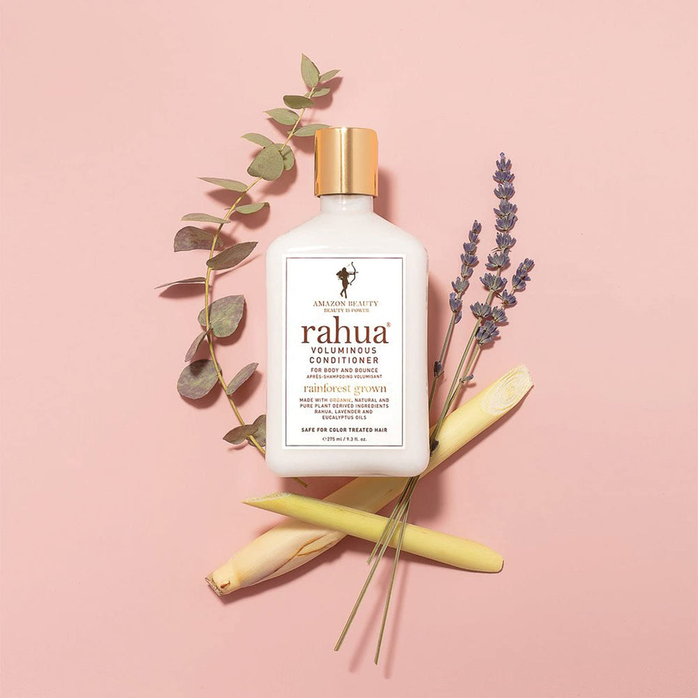 Rahua bottle in hand for scale illustrating the 9.3 fl oz travel-friendly size