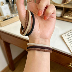 Random Mood band stretched to show elasticity and firm hold for thick hair