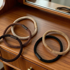Random Mood ponytail secured with a band in neutral tone, steady hold without creases