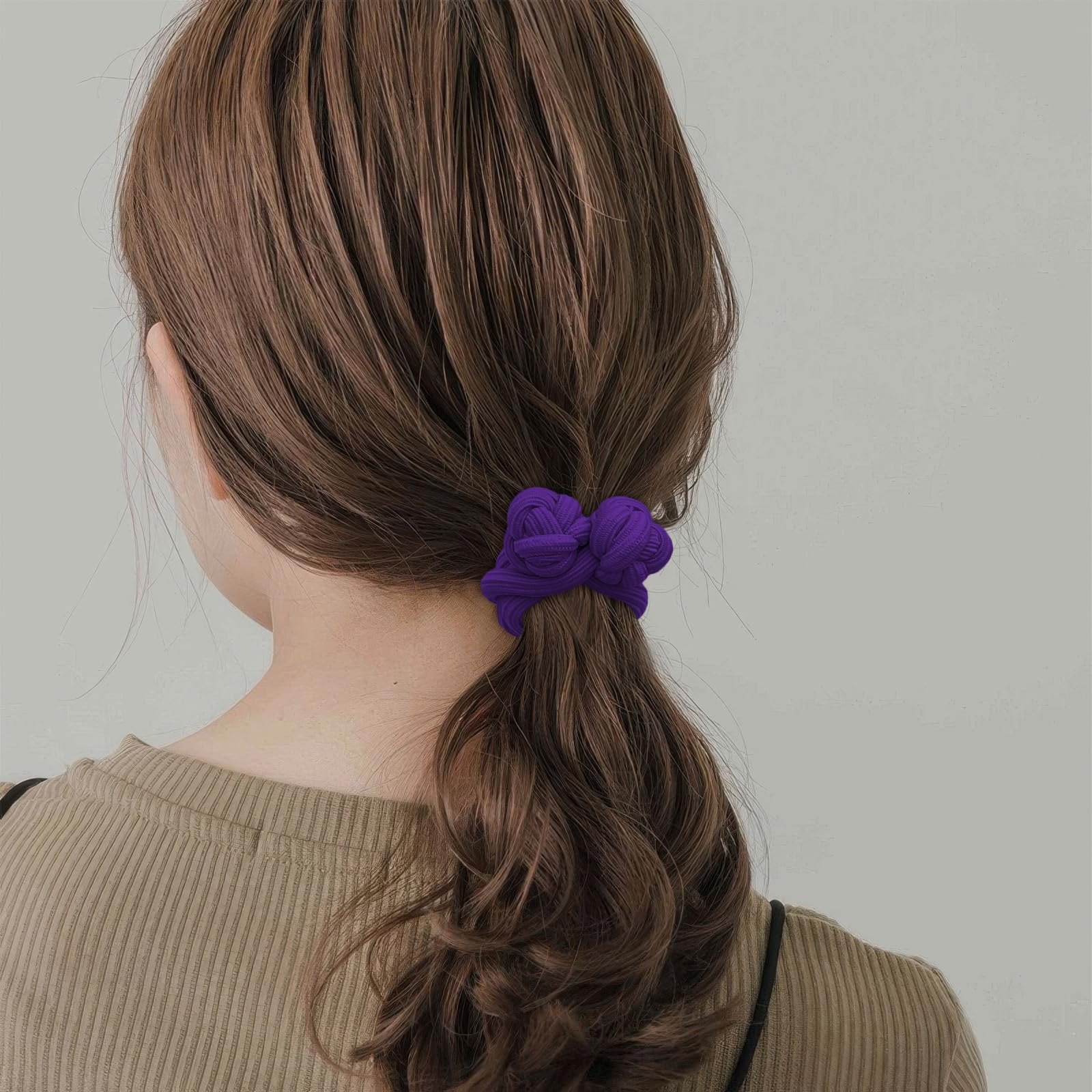 Ravlzors lifestyle image of woman tying hair for comfortable wear