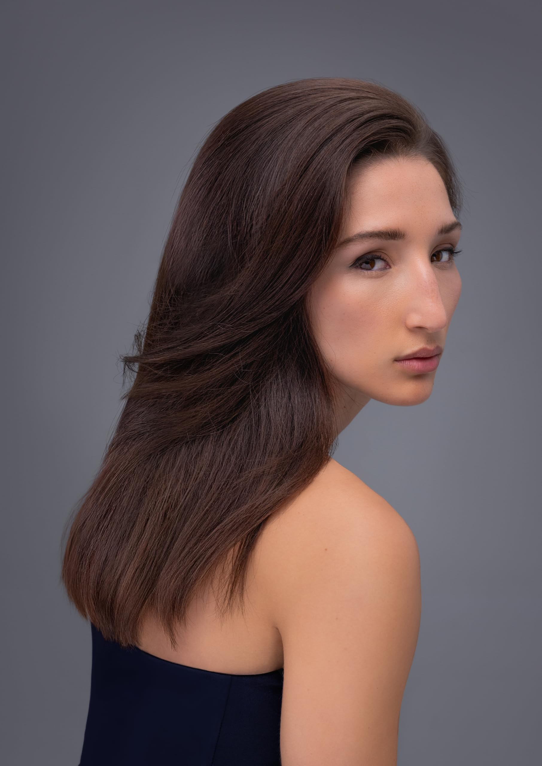 R+Co BLEU 4.2 oz beside hand indicating compact travel-friendly size