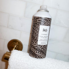 R+Co Chainmail 5 oz bottle next to a ruler to show travel-friendly size