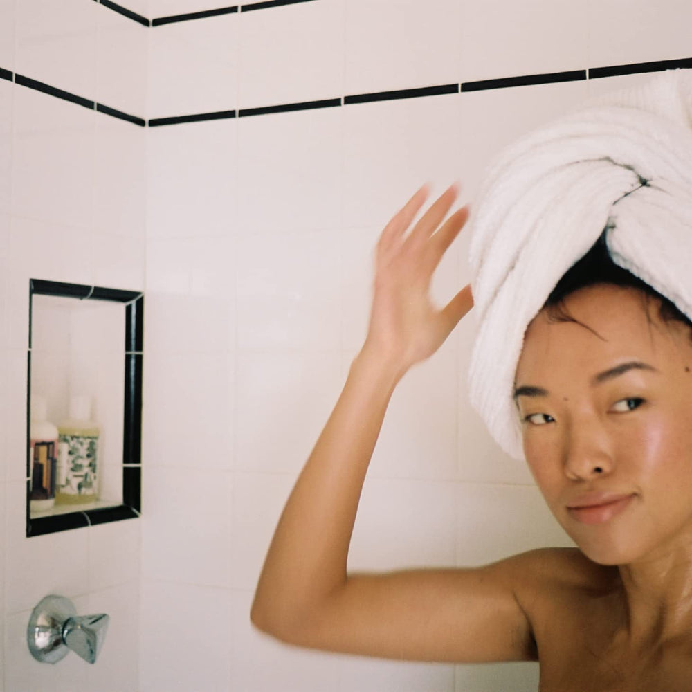R+Co Dallas in-shower use showing lifted hair and improved volume after cleansing