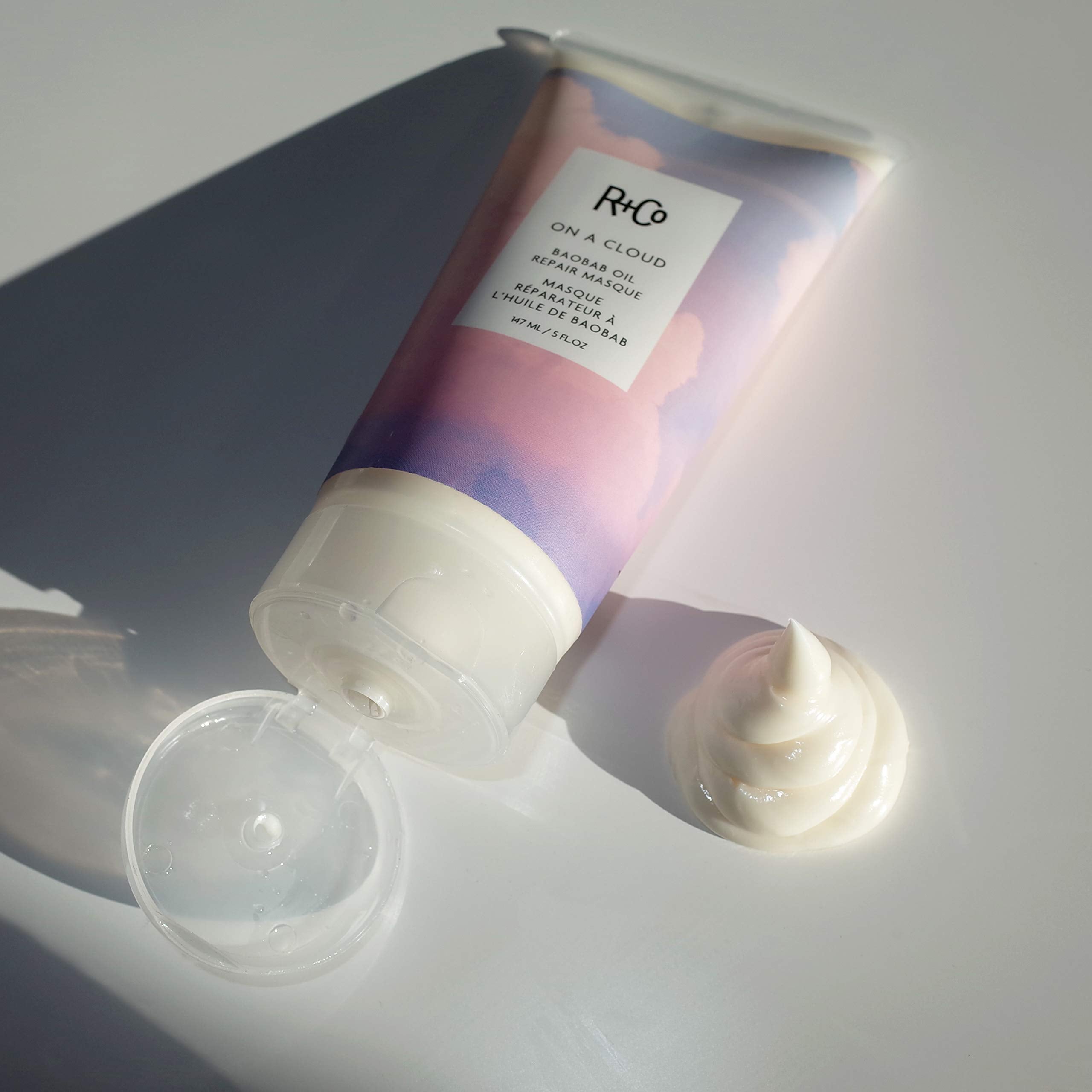 R+Co applying masque to wet hair demonstrating deep conditioning