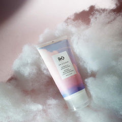 R+Co jar held in hand to show 147 ml scale and travel convenience