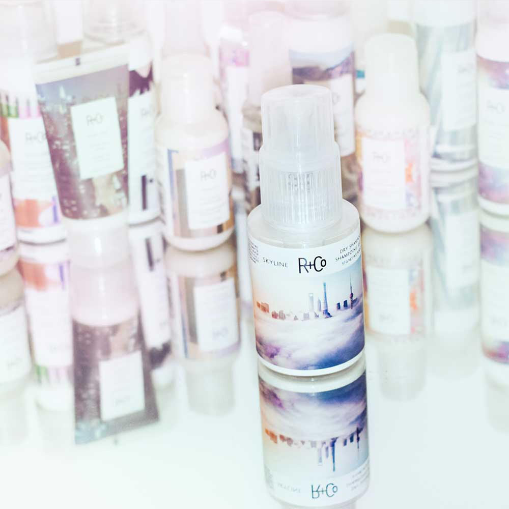 R+Co Skyline on a bathroom vanity staged for daily styling and convenience benefit