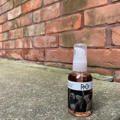 R+Co two way mirror applied on hair ends showing smooth frizz-control benefit