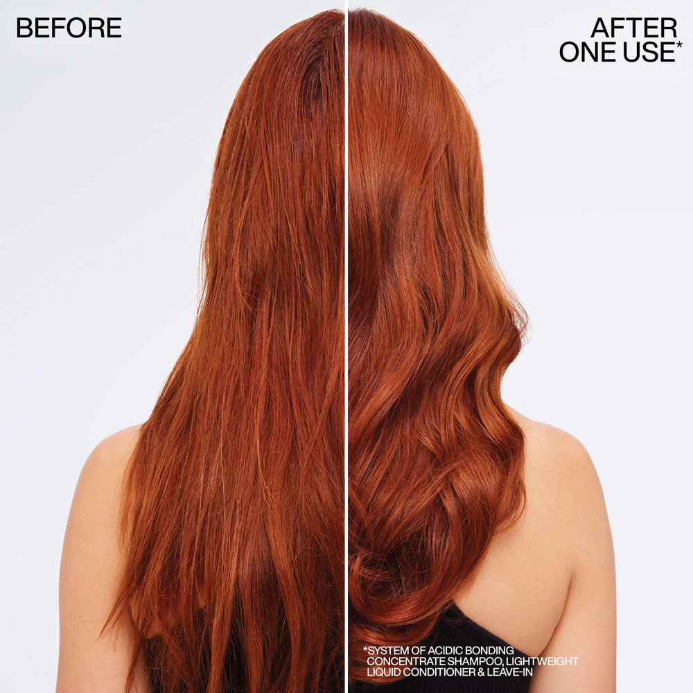 Redken conditioner on hair strand held in hand showing softer feel