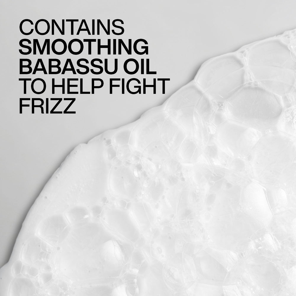 Redken Frizz Dismiss mask being applied to damp hair showing improved detangling benefit