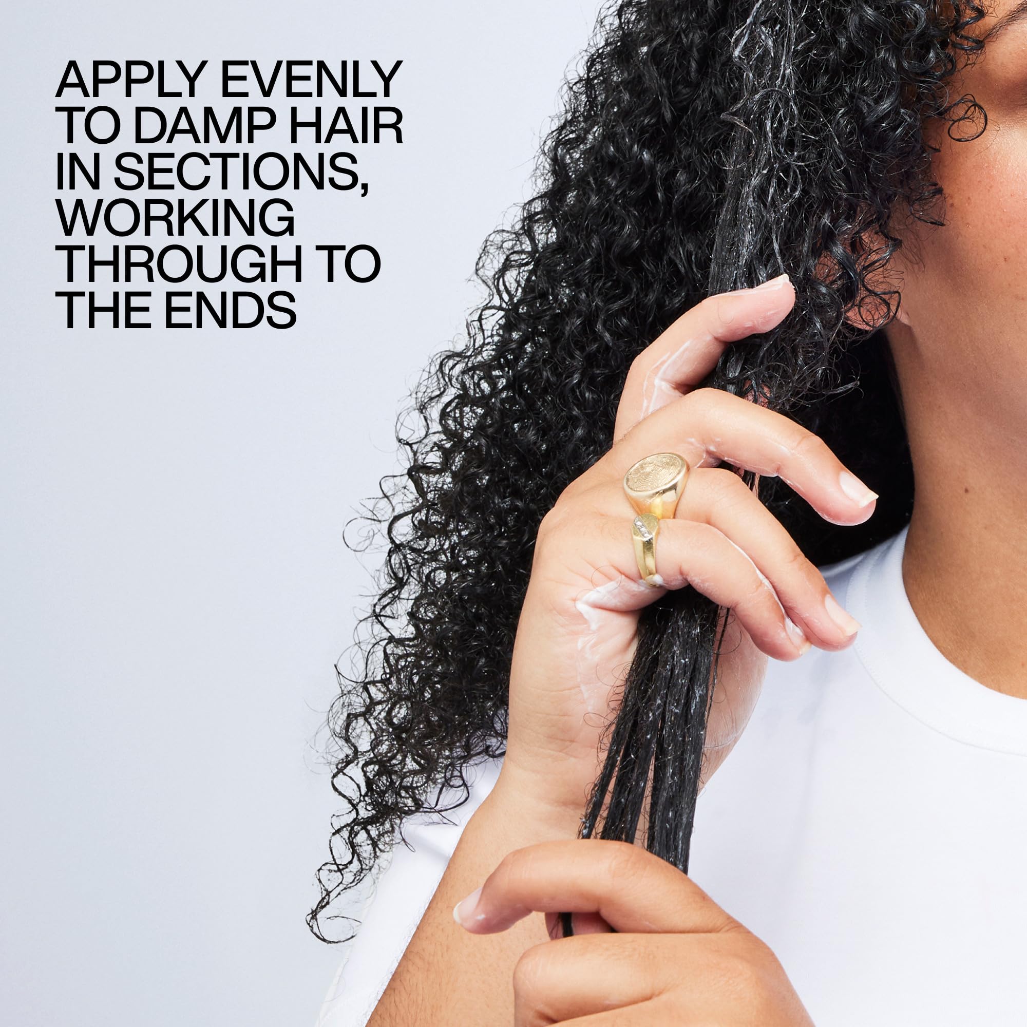 Redken on curly hair while diffusing demonstrating heat protection and definition