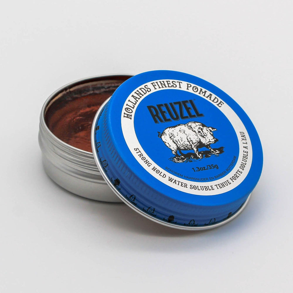 REUZEL Blue Pomade creamy texture in hand demonstrating smooth application and pliable hold