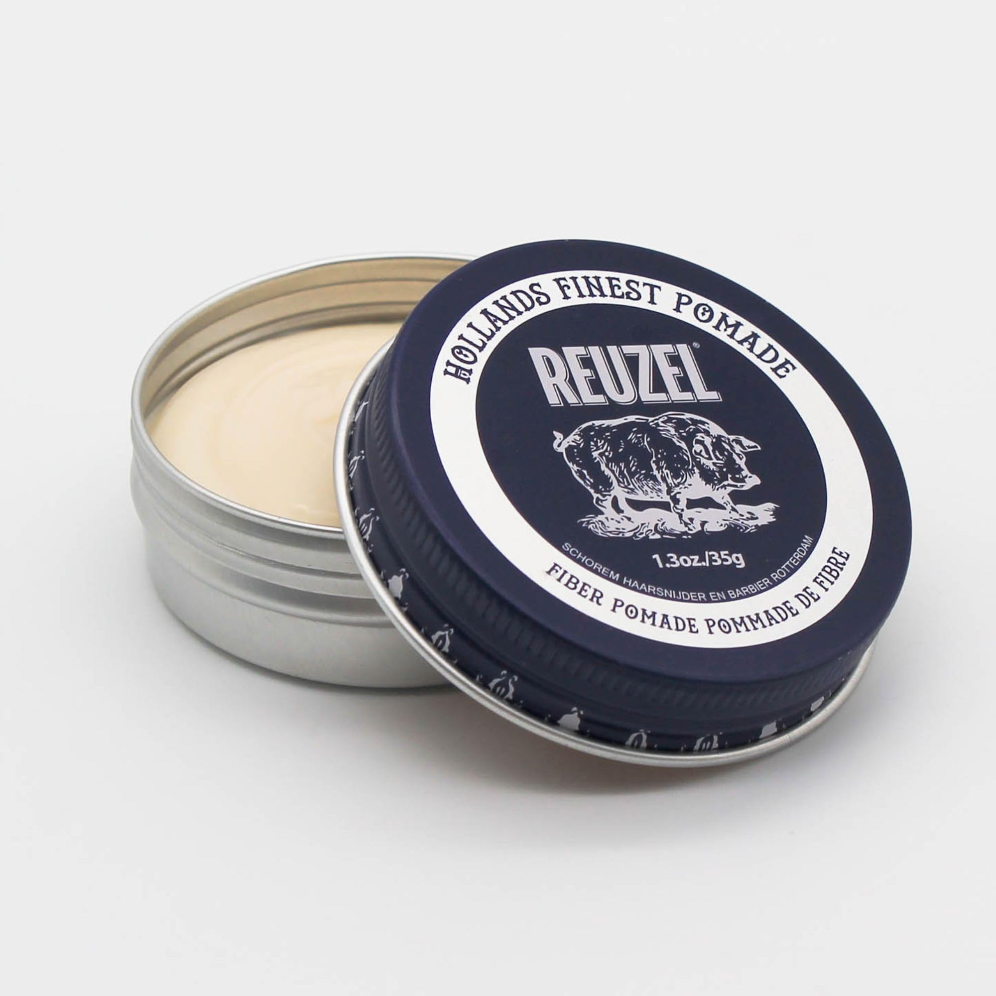 REUZEL pomade texture close-up on fingers demonstrating pliable hold and matte finish