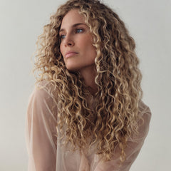 REVERIE applied to damp hair demonstrating smoother, detangled strands