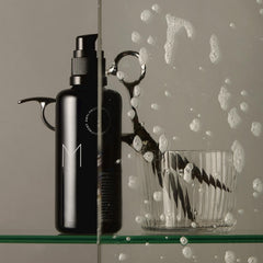 REVERIE on a bathroom shelf in a lifestyle scene suggesting daily use