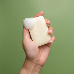 REVITALE soap bar held in hand to show true size and portability