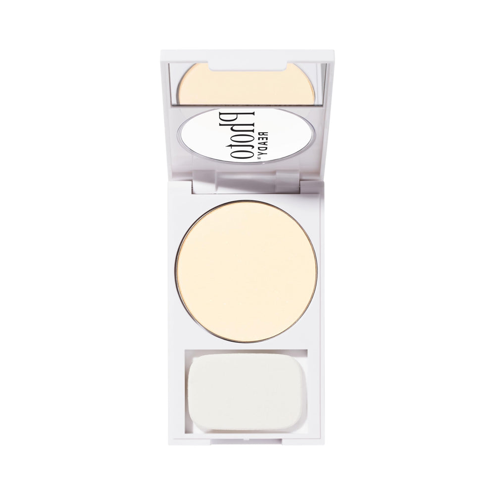 Revlon compact beside hand showing size with brush for convenient touchups