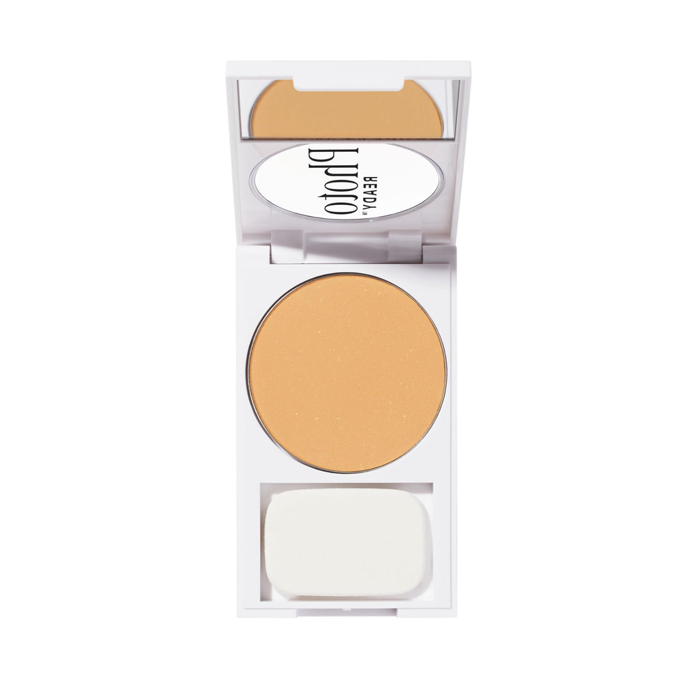 Revlon compact next to hand to show size with brush for on-the-go touch-ups