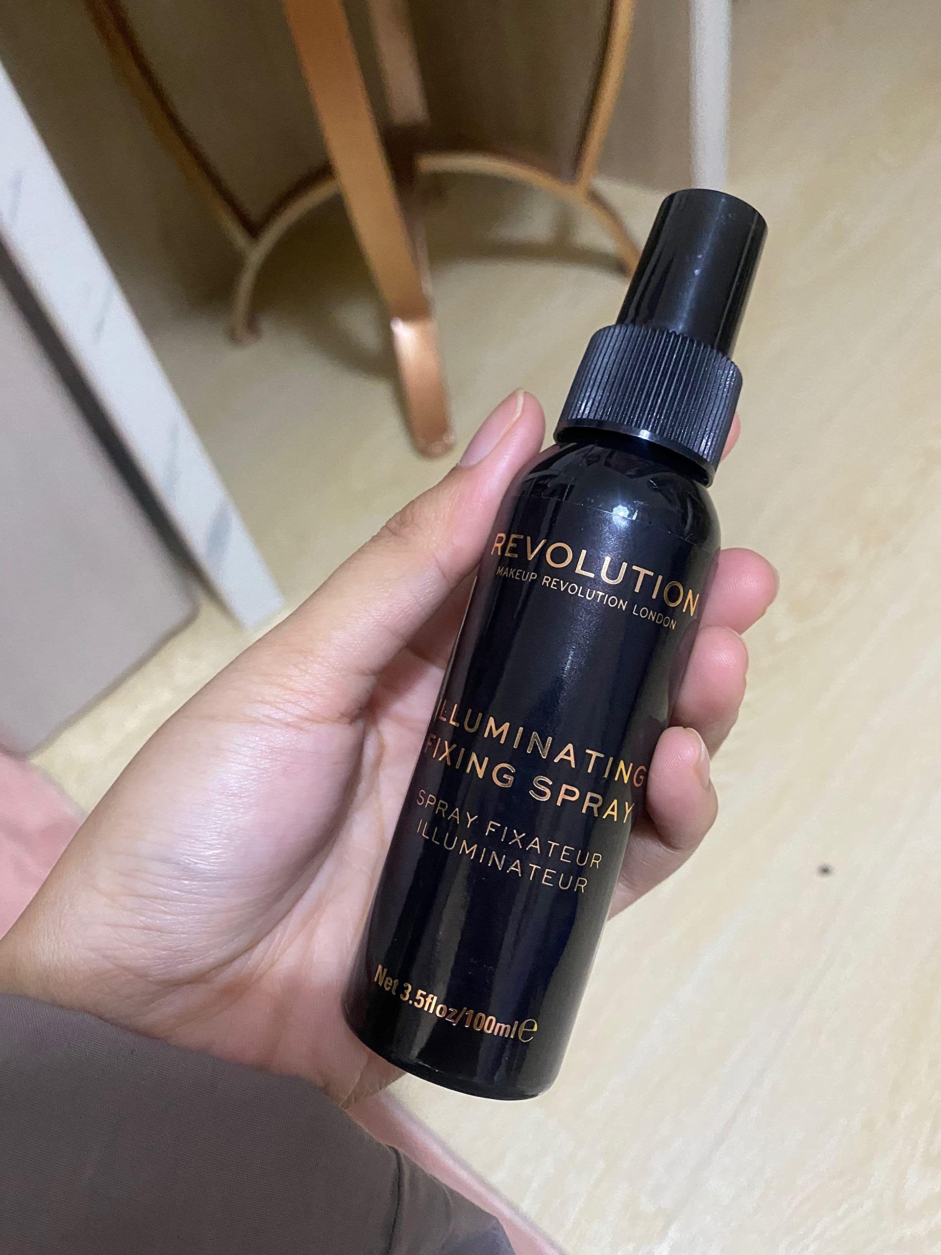 Revolution Beauty London spray in use on model demonstrating sweat-resistant makeup benefit