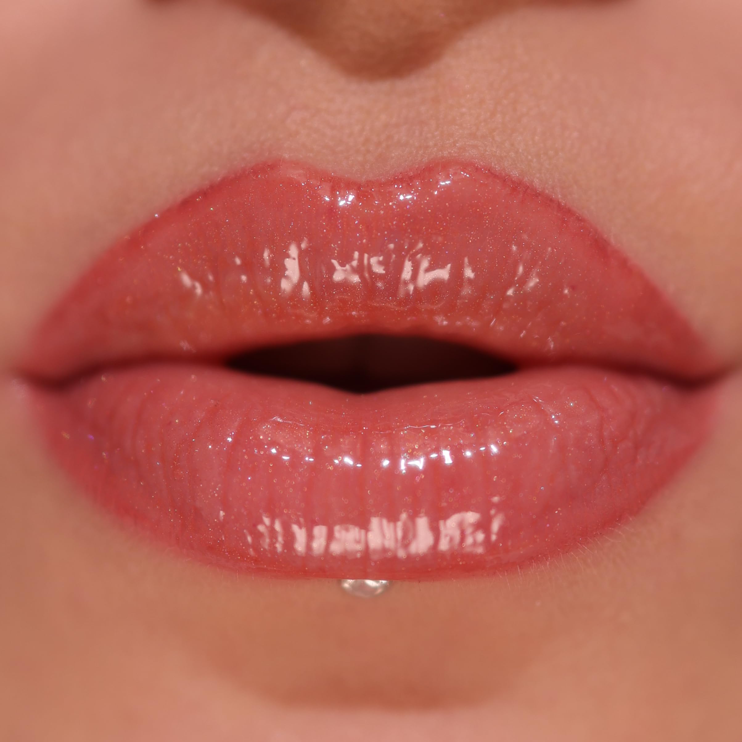 Revolution Skincare London gloss texture swatch on hand showing shimmer and hydrating finish benefit