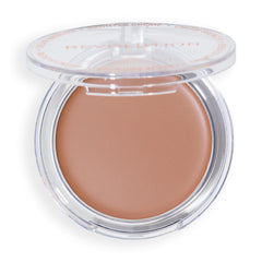 Revolution Beauty London compact held in hand showing portable size and travel convenience