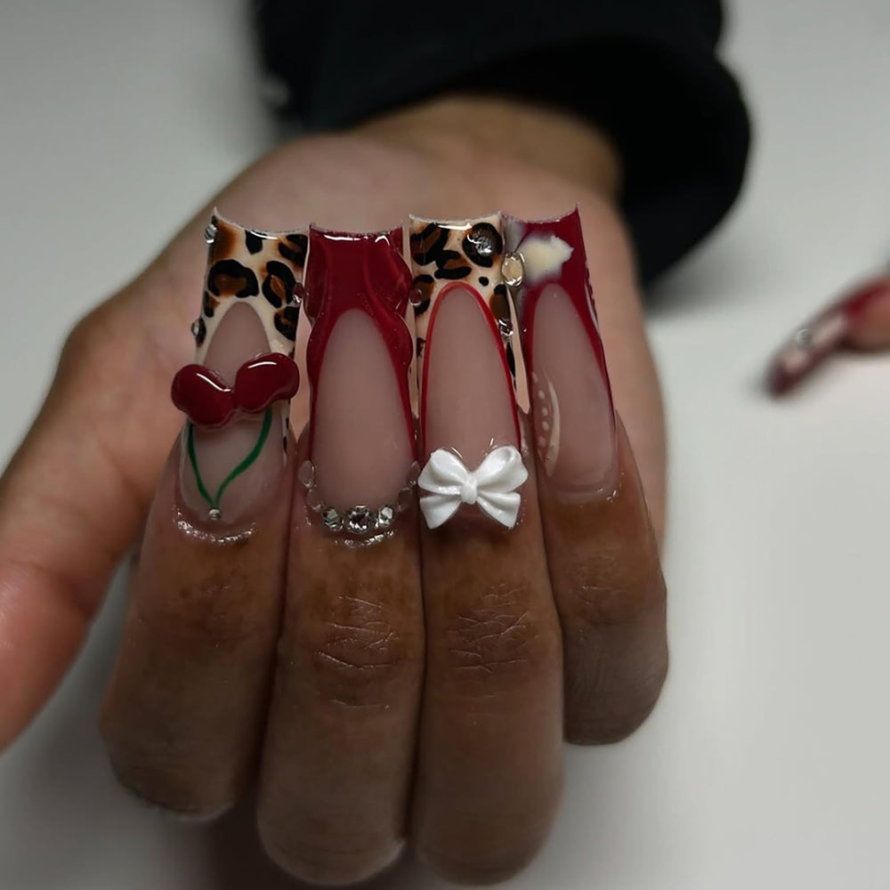 RIICFDD cherry charm detail on nail highlighting decorative accent appeal