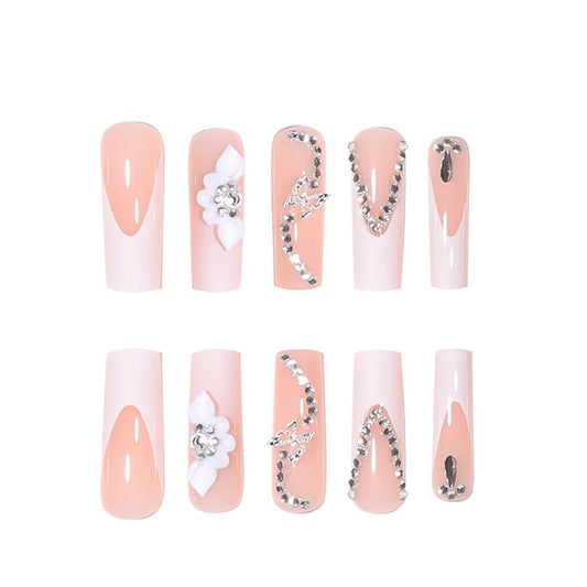 RikView close-up of 3D flower detail on white nail showing textured floral accent for elegant looks