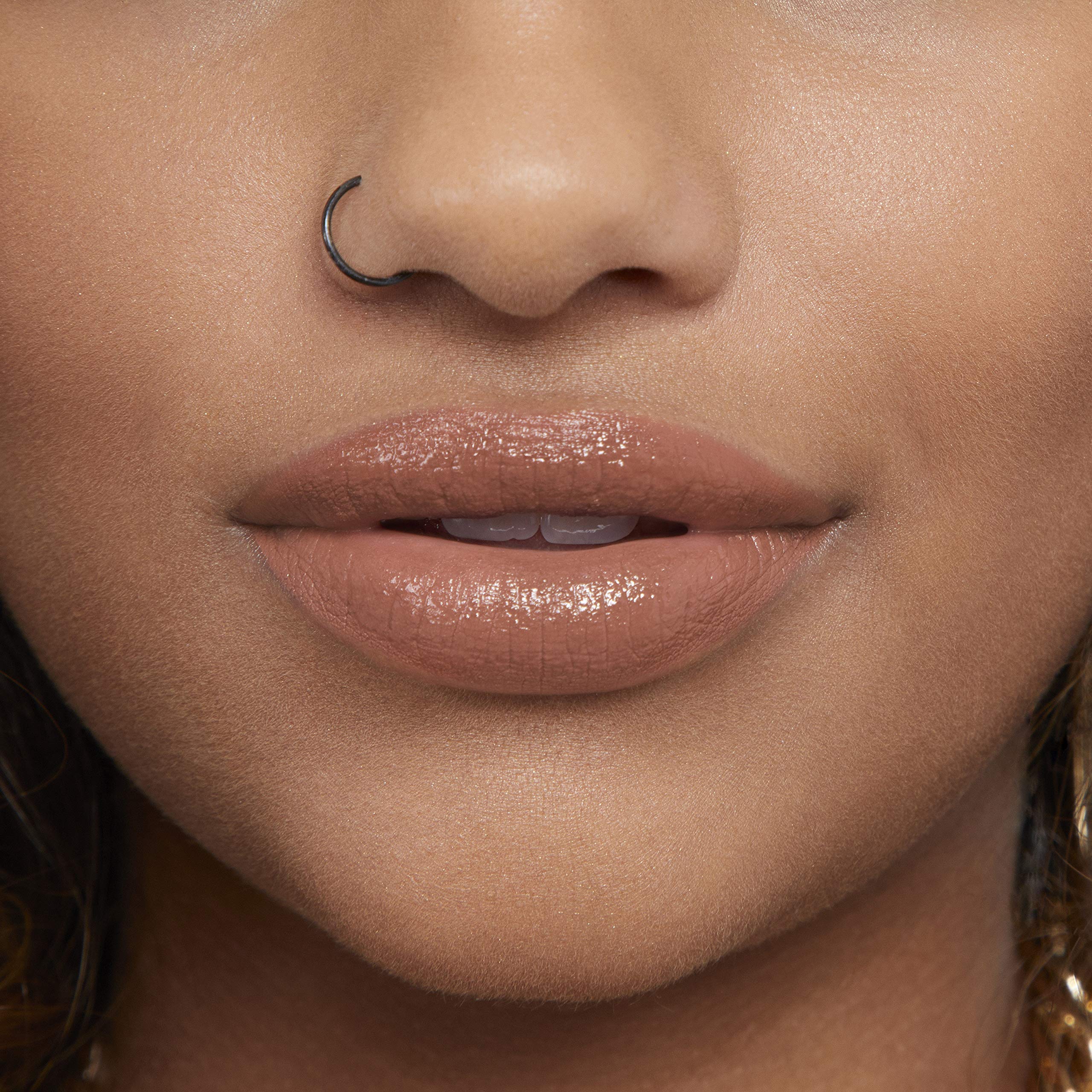 Rimmel Provocalips tube beside coin illustrating compact travel-friendly size
