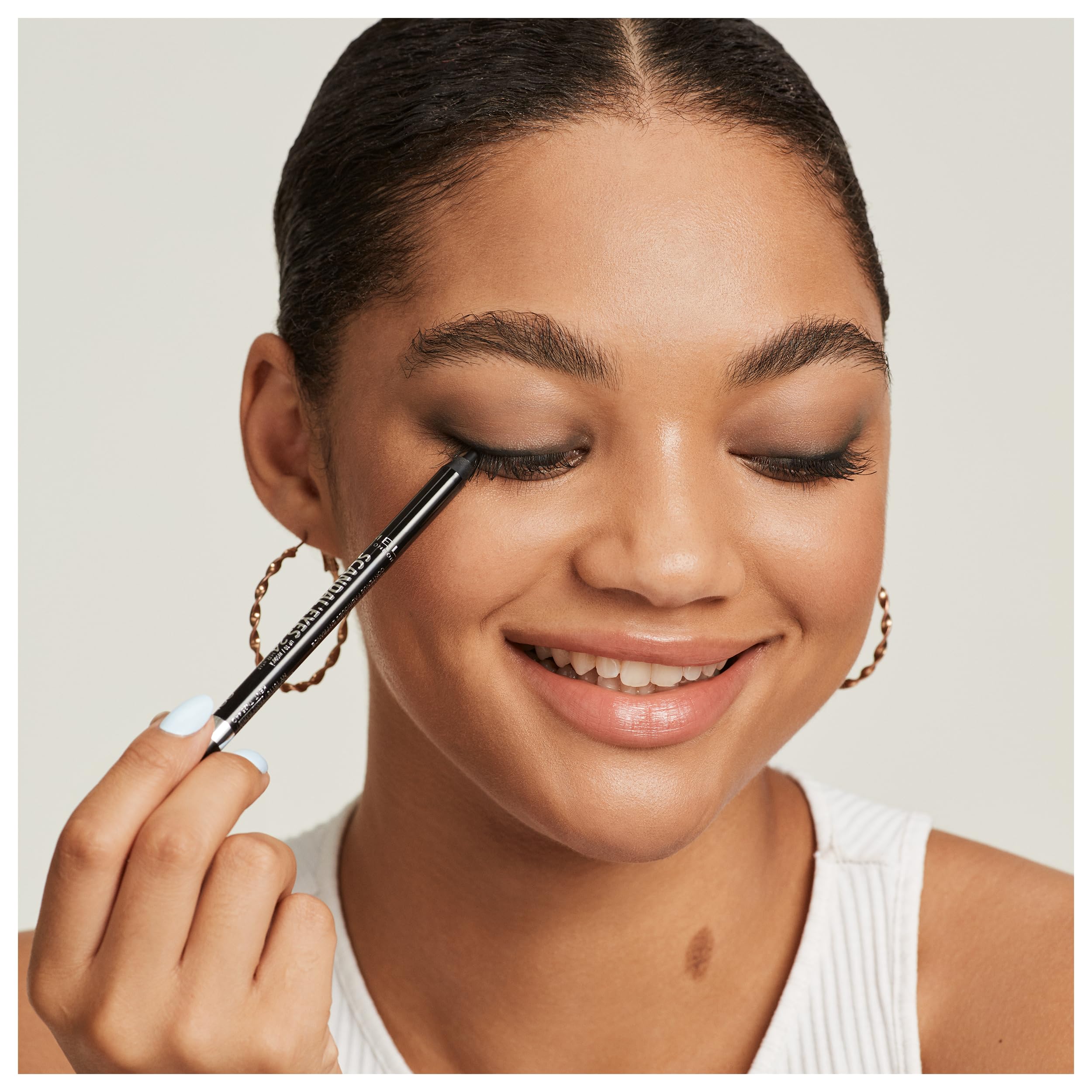 Rimmel Scandal'eyes inside a makeup bag lifestyle shot highlighting portability and everyday convenience