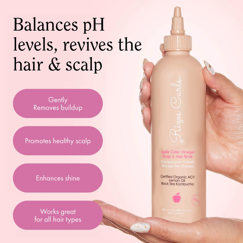Rizos Curls 2.5 oz bottle beside a passport showing travel-friendly size and easy packing