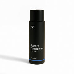 Ro bottle front view showing product and benefit of fuller-looking hair