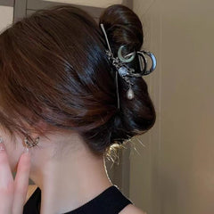 ROMODIYA clip in use securing a half-up hairstyle for convenience