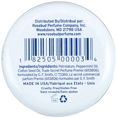 Rosebud Perfume tin in a handbag showing portability and on-the-go moisture benefit