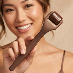 ROSELYNBOUTIQUE derma roller being used on jawline illustrating easy at-home use