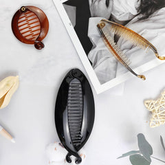ROYHOO clip in hand to show size and lightweight build aiding travel packing convenience