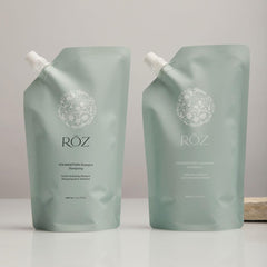 RŌZ pouch pouring shampoo into aluminum bottle for reuse
