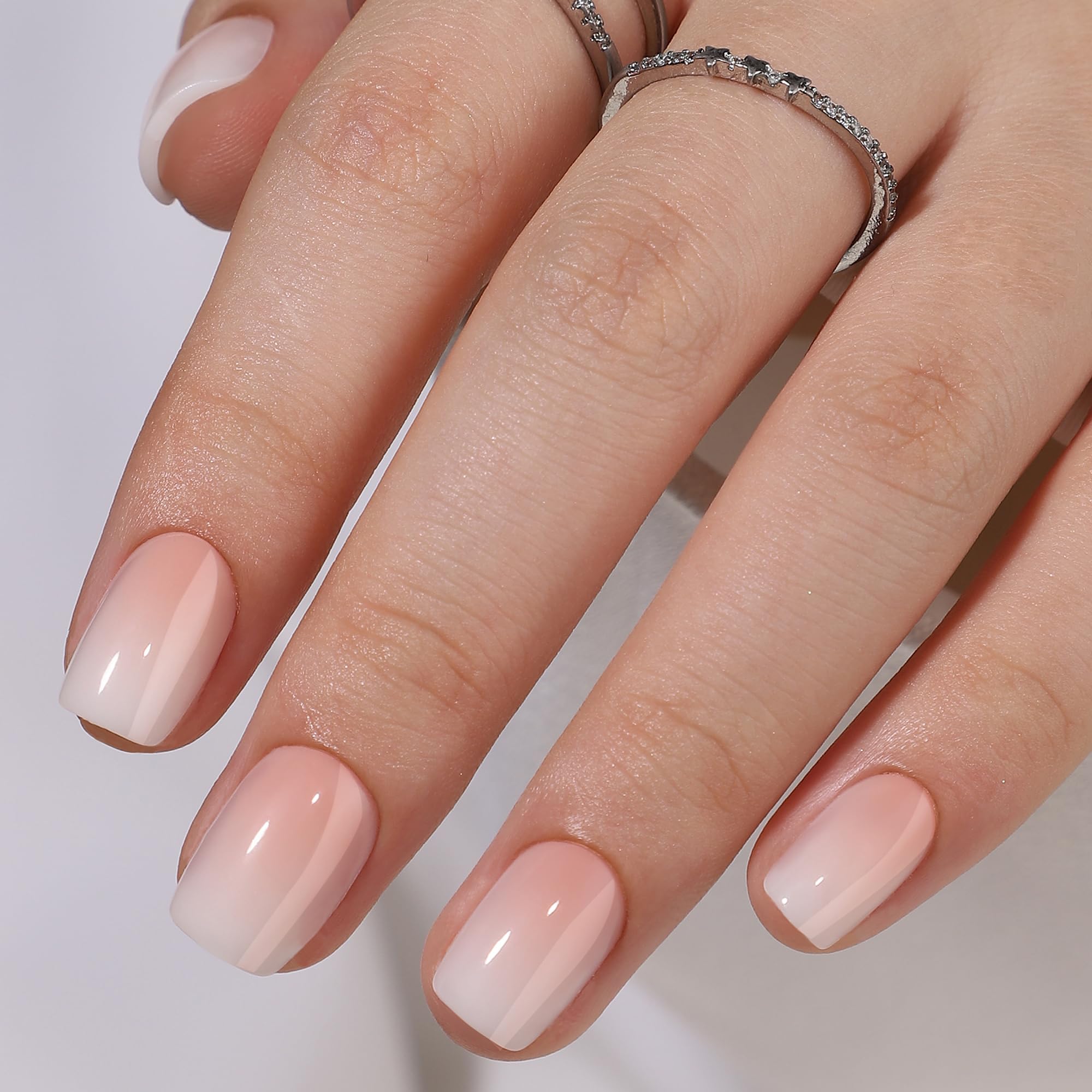 RPNZL close-up of peach ombre French tip texture for glossy finish