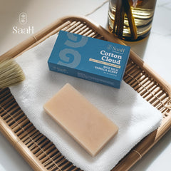 SAAH cotton cloud bar held in hand for scale showing compact 5 oz size convenience
