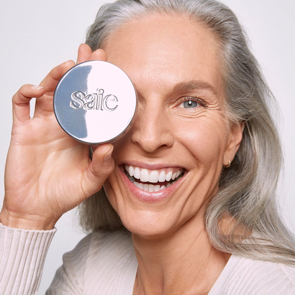Saie compact next to common object showing 0.14 oz travel-friendly size